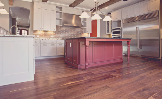 Wide Plank Black Walnut floor in kitchen with antique Heart Pine beams by Oak & Broad