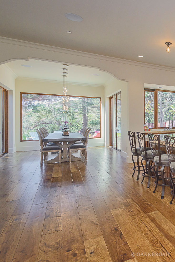 Wide Plank Hand-Scraped Hickory Hardwood Floor by Oak and Broad | dining area and kitchen bar showing unique rustic architecture