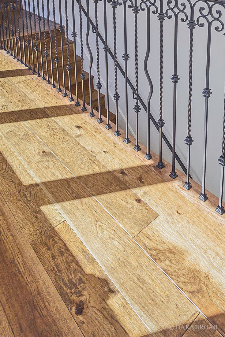 Wide Plank Hand-Scraped Hickory Hardwood Floor by Oak and Broad | wrought iron details with rustic floor