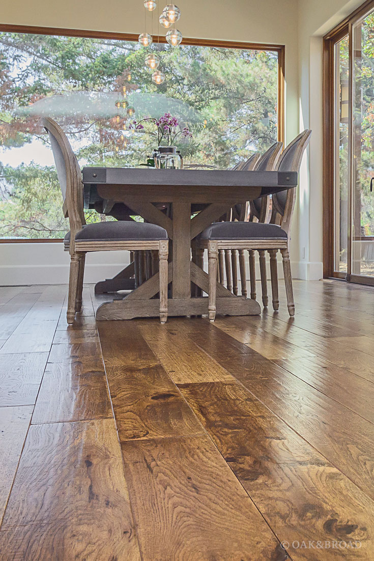 Wide Plank Hand-Scraped Hickory Hardwood Floor by Oak and Broad | detail of heavy farm table complimenting rustic hand scraped floor