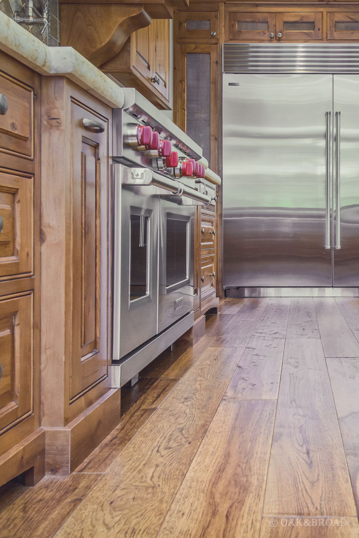 Wide Plank Hand-Scraped Hickory Hardwood Floor by Oak and Broad | professional cooking appliances in rustic kitchen