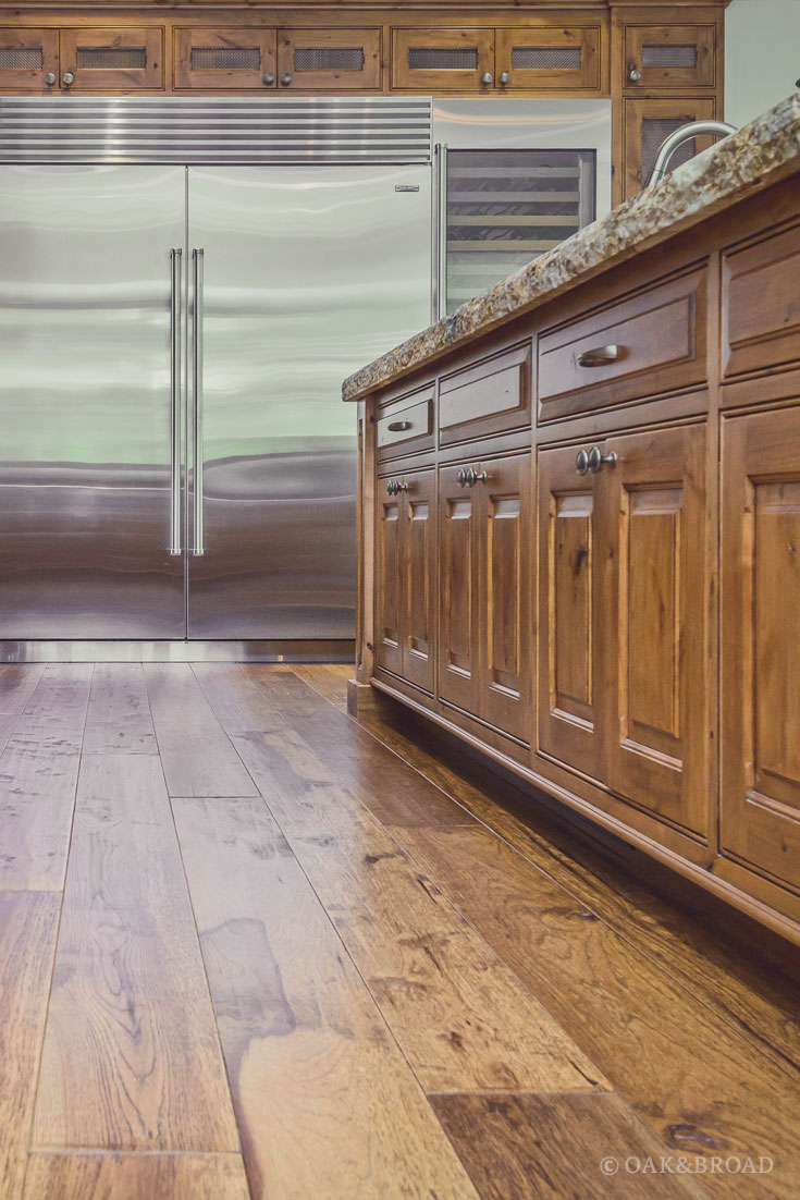 Wide Plank Hand-Scraped Hickory Hardwood Floor by Oak and Broad | Rustic kitchen with extra large stainless steel refrigerator