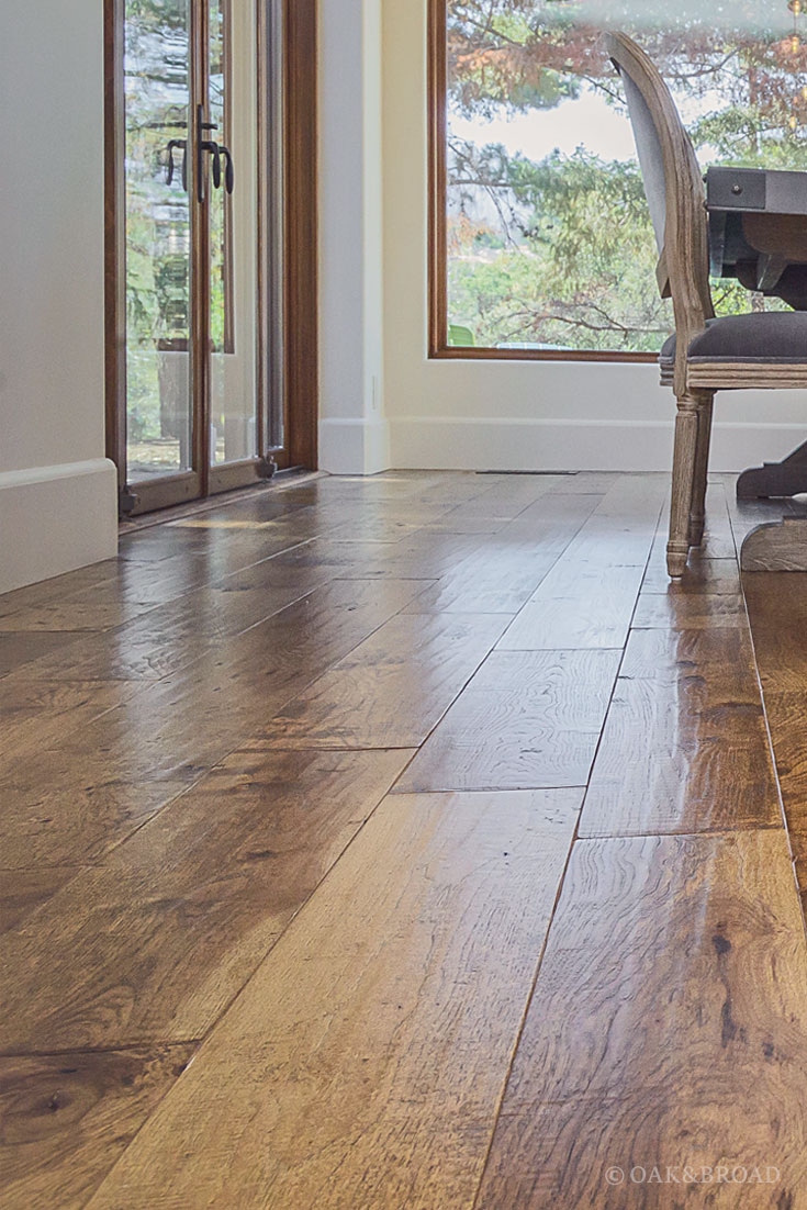 Wide Plank Hand-Scraped Hickory Hardwood Floor by Oak and Broad | Light reflecting off of unique hand-scraped texture