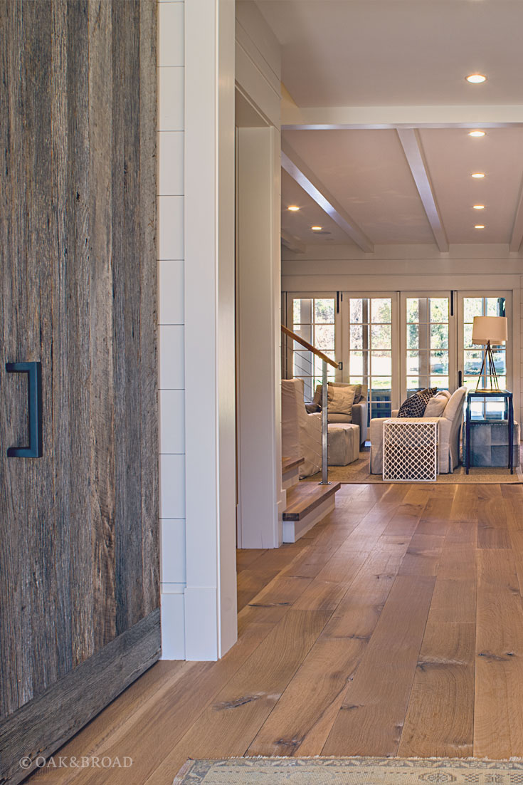 Wide Plank White Oak Hardwood Floor by Oak and Broad with Custom Stain | Reclaimed wood and iron hardware add a sense of drama to this rustic modern home