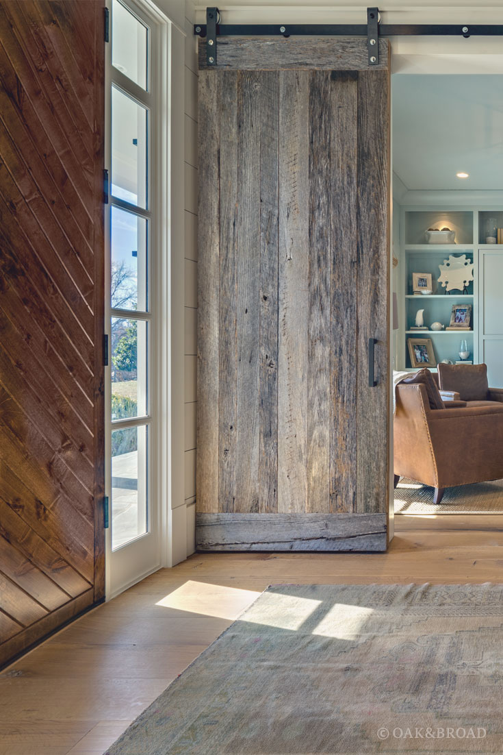 Wide Plank White Oak Hardwood Floor by Oak and Broad with Custom Stain | Entryway with eclectic reclaimed style wood barn doors in rustic modern Tennessee home