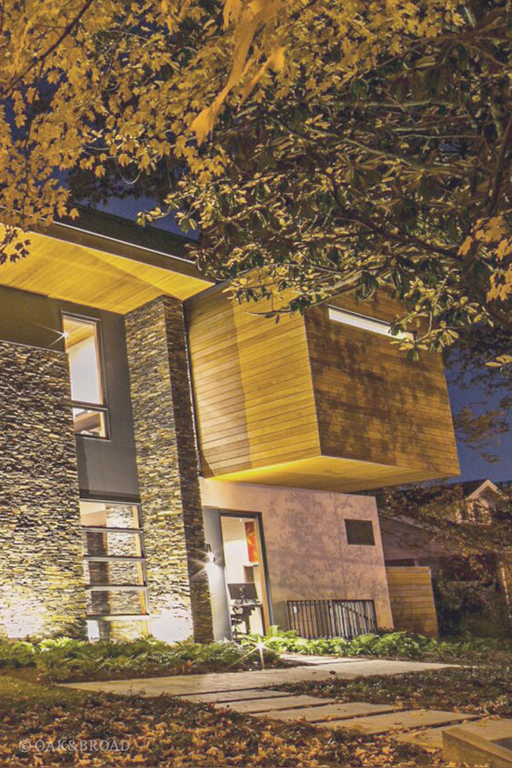 Wide Plank Black Walnut Hardwood Floor by Oak and Broad | Exterior of modern home at night with dramatic lighting
