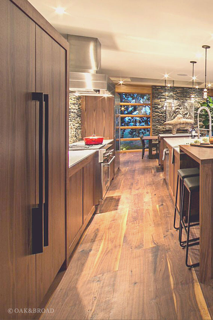 Wide Plank Black Walnut Hardwood Floor by Oak and Broad | Modern kitchen area with black walnut and stone, stainless steel appliances