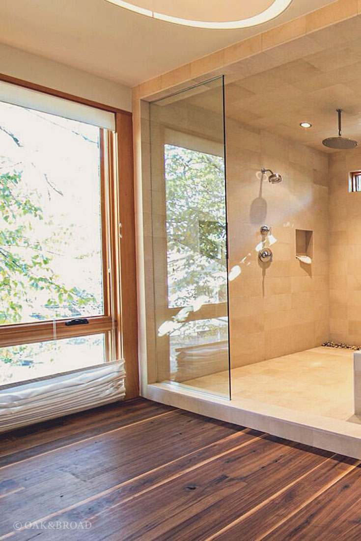 Wide Plank Black Walnut Hardwood Floor by Oak and Broad | Beautiful modern bathroom with tile shower contrasting with our black walnut floor, large windows for natural light