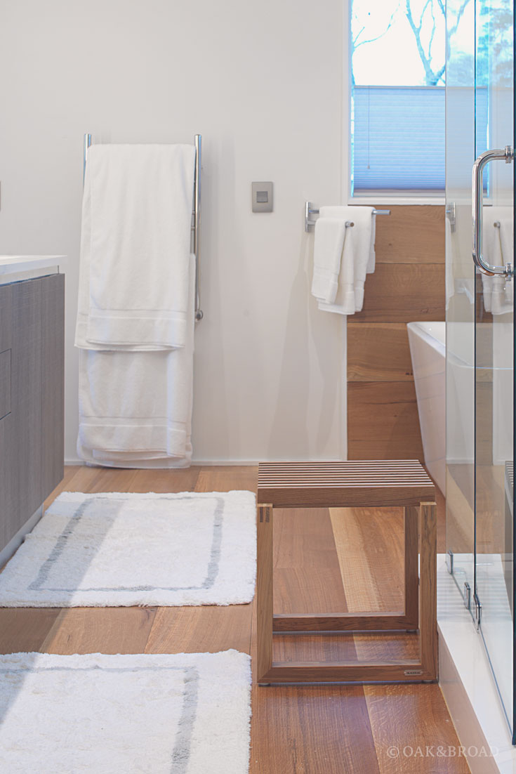 Wide Plank White Oak Hardwood Floor by Oak and Broad | Modern bathroom with lots of natural light and white linens