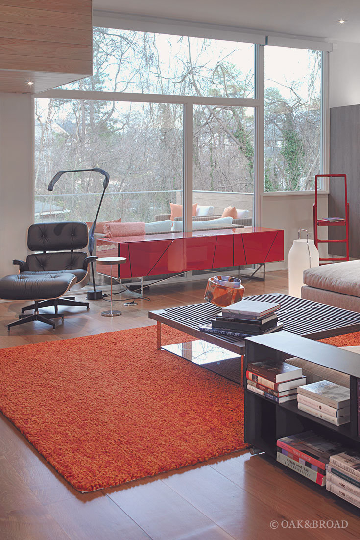 Wide Plank White Oak Hardwood Floor by Oak and Broad | Modern living area with orange shag carpet and Eames Lounger