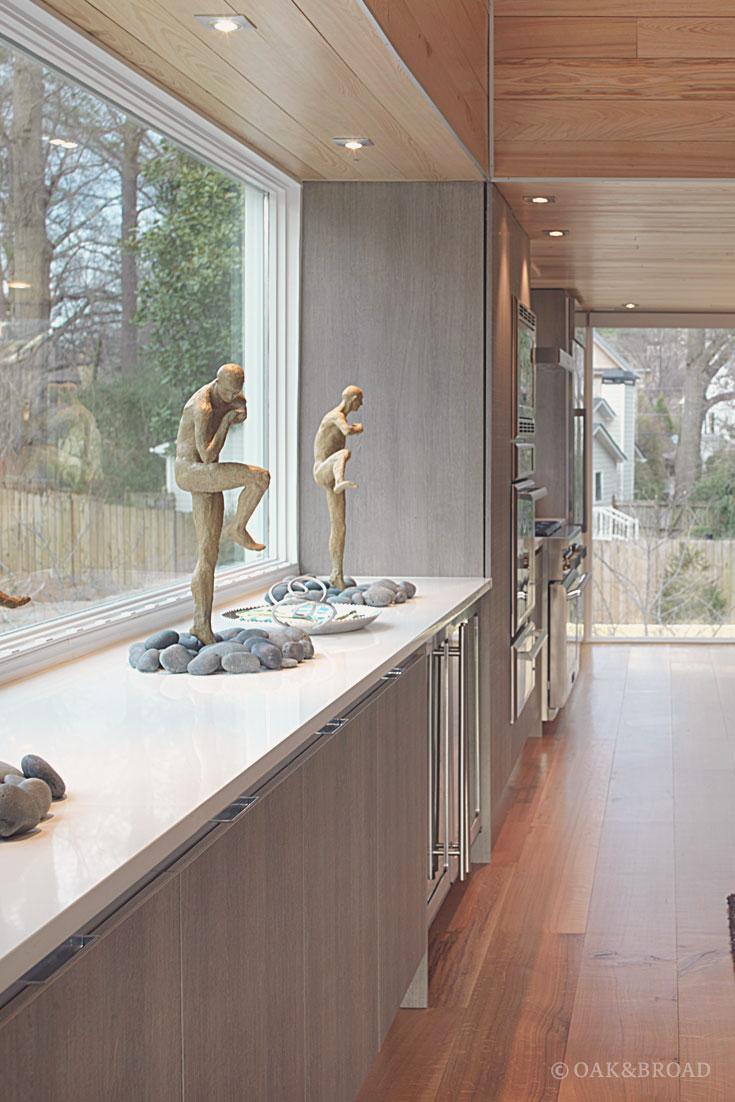 Wide Plank White Oak Hardwood Floor by Oak and Broad | Modern kitchen with sculptures and white counter tops