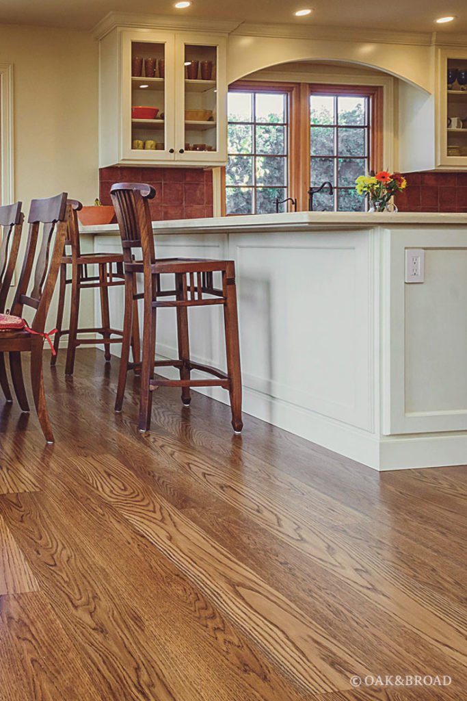 Kitchen with wide plank hardwood floor by Oak & Broad