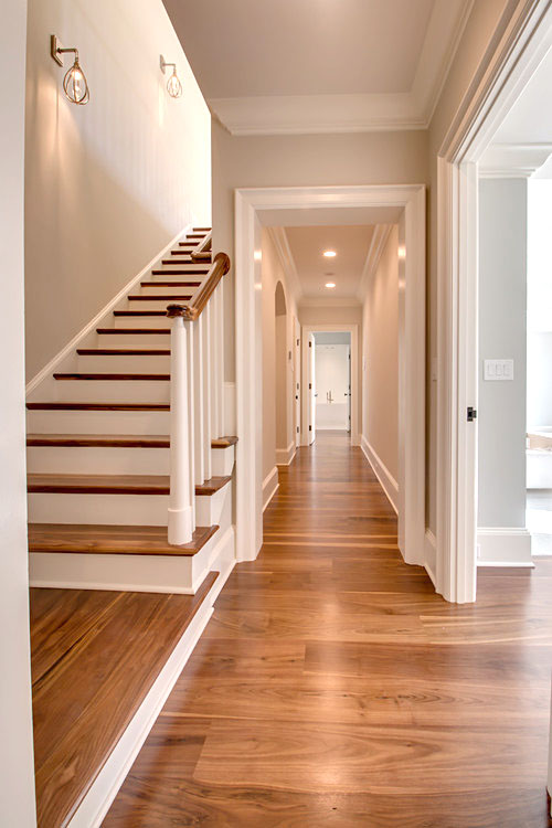 Stairway and hallway with Black Walnut floor by Oak & Broad