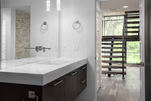 Bathroom in modern home with black walnut wide plank floor by Oak & Broad
