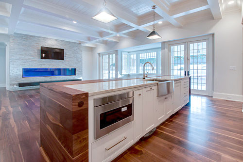 Kitchen and windows with Black Walnut floor by Oak & Broad