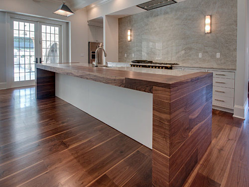 Black walnut countertop with matching floor by Oak & Broad