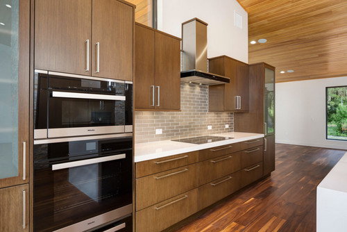 Kitchen in modern home with black walnut wide plank floor by Oak & Broad