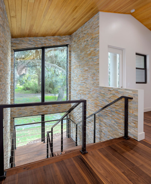 Stairway in modern home with black walnut wide plank floor by Oak & Broad