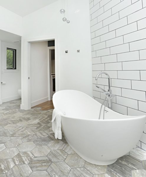 White Bathroom With Bath Tub- Oak And Broad